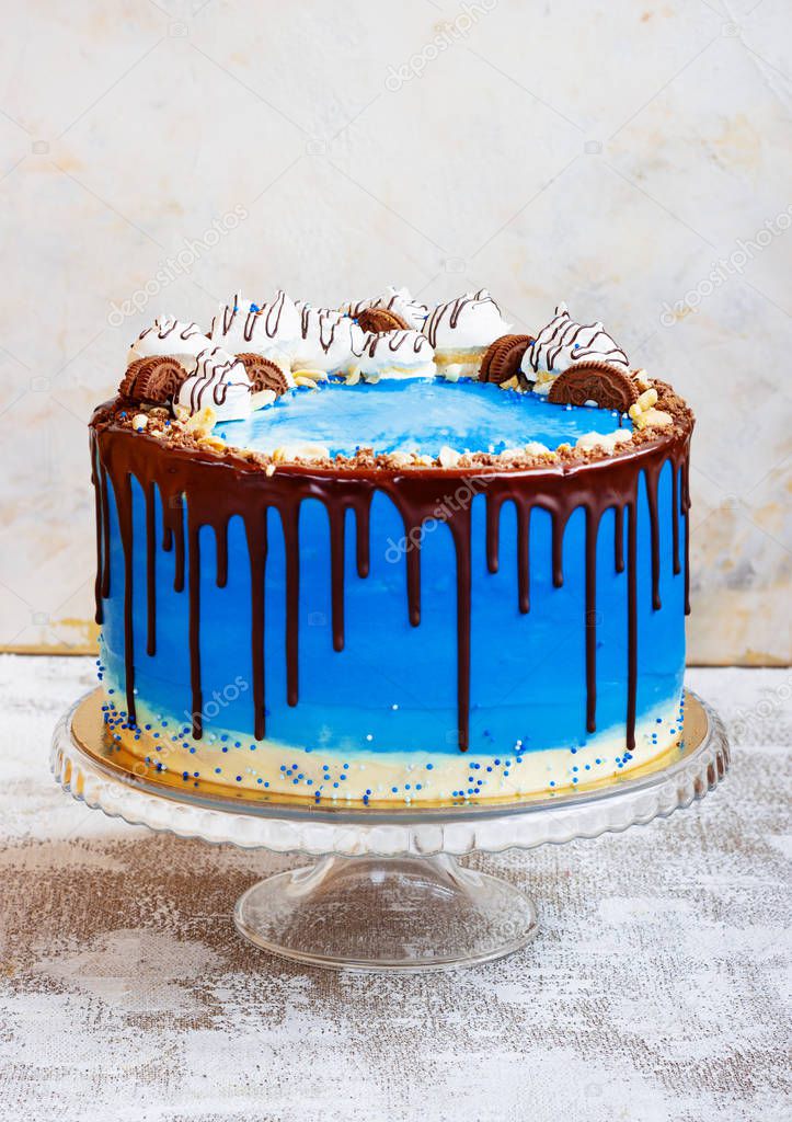 Blue cream cake in a marine style on a light backgroundwith chocolate