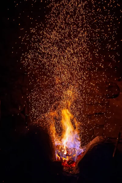 Smithy fire flame tips with sparks closeup — Stock Photo, Image