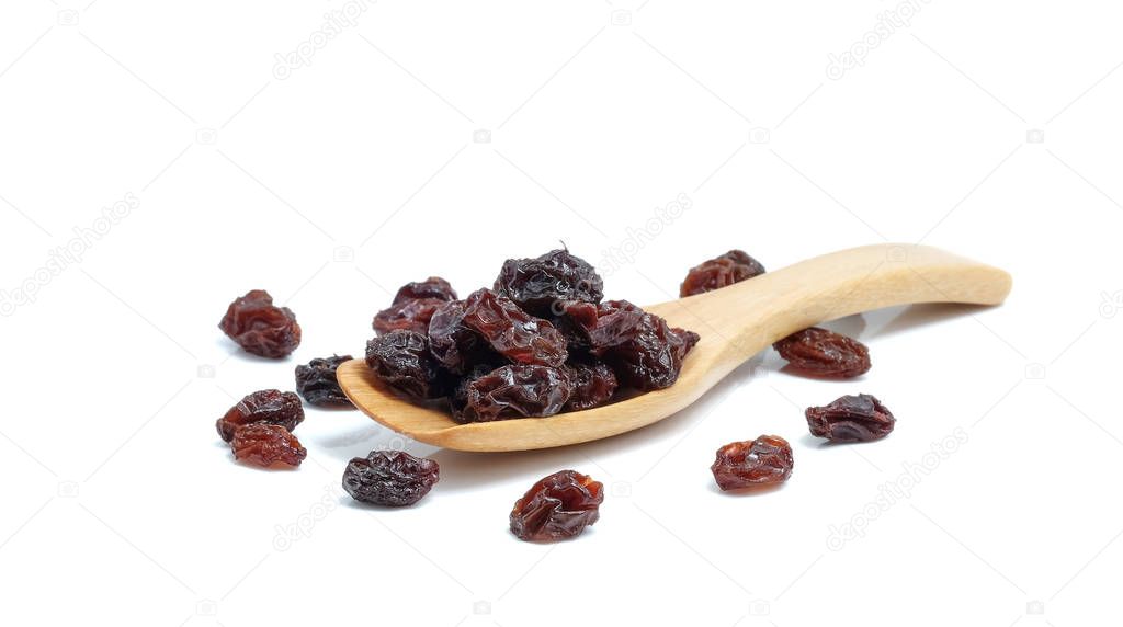 Dried grapes in wood spoon on white background.
