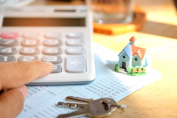 House model and key with calculator on book bank. — Stock Photo, Image
