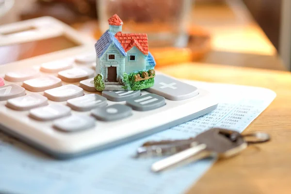 House model and key with calculator on book bank. — Stock Photo, Image