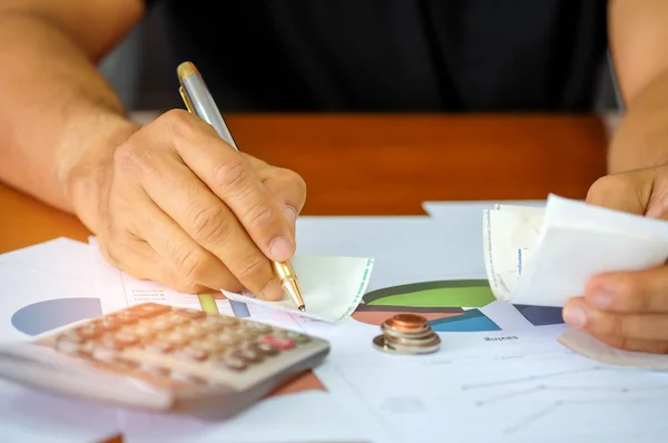 Men are using a calculator to analyze slip credit card. — Stock Photo, Image