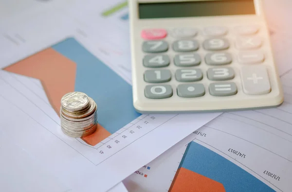 Concept businness,Coin and calculator placed on the graph. — Stock Photo, Image