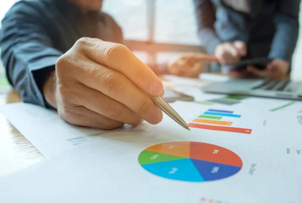 Two office workers are analyzing graph data,Office worker has a — Stock Photo, Image