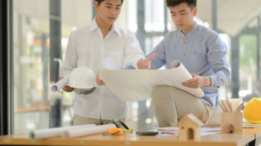 Mimarlar ve mühendisler planları inceler ve tasarım ve inşaat planlaması için danışmanlık yaparlar..