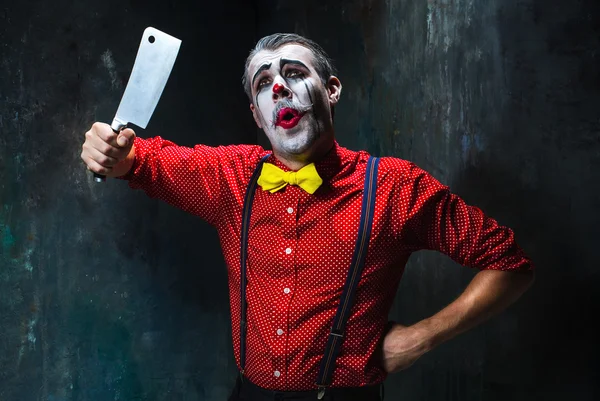 The scary clown holding a knife on dack. Halloween concept — Stock Photo, Image