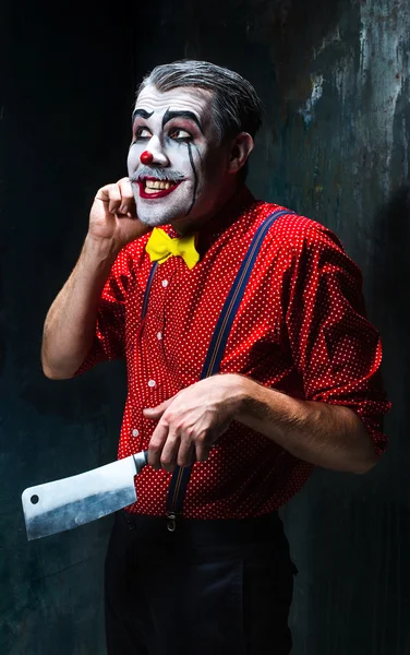 Сумасшедший клоун, держащий нож на прицеле. Концепция Хэллоуина — стоковое фото