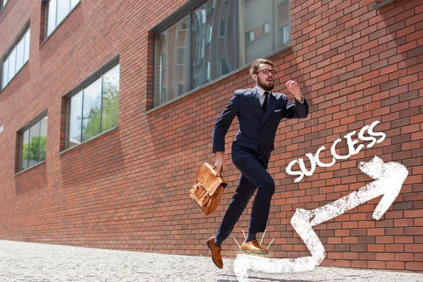 young businessman running in a city street