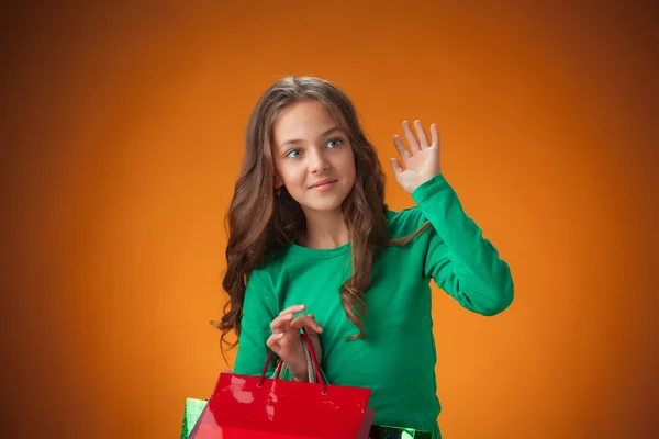 The cute cheerful little girl with shopping bags — Stockfoto