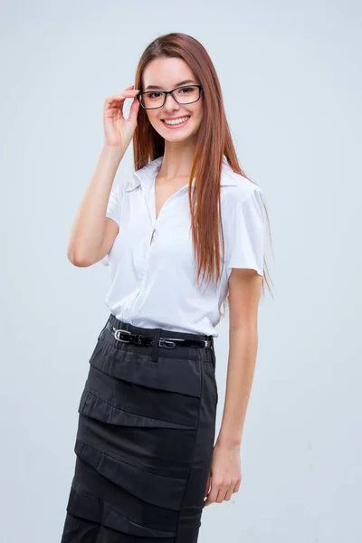 La giovane donna d'affari sorridente su sfondo grigio — Foto Stock