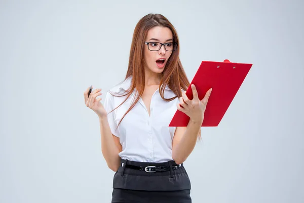 The young business woman with pen and tablet for notes on gray background — Stock Photo, Image