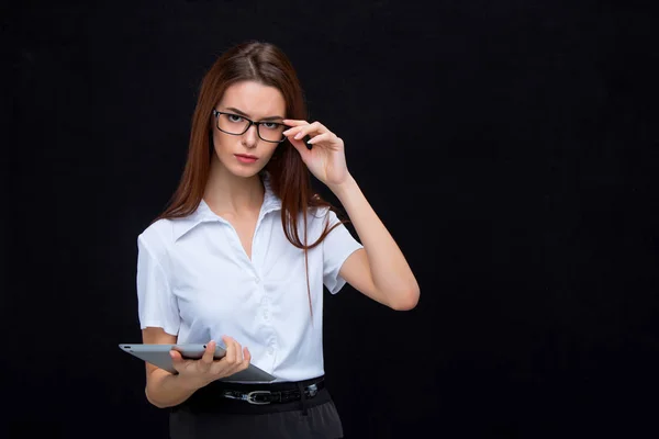 The young business woman with tablet on black background — Stock Photo, Image