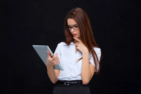 The young business woman with tablet on black background — Stock Photo, Image