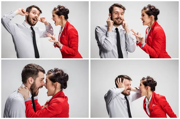 El hombre y la mujer de negocios que se comunican sobre un fondo gris —  Fotos de Stock