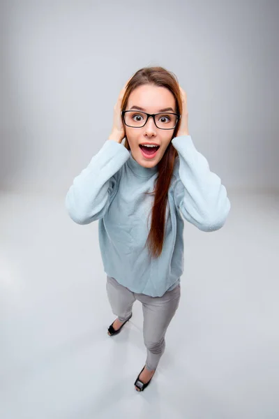 Die lächelnde junge Geschäftsfrau auf grauem Hintergrund — Stockfoto