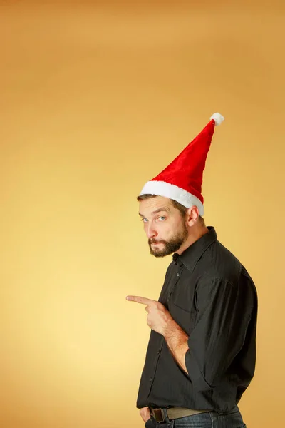 Noel Baba şapkası giyen ciddi Noel adam — Stok fotoğraf