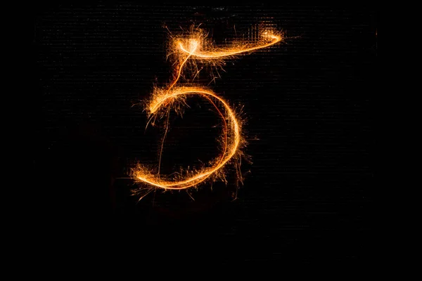 Number 5 made of sparklers on black — Stock Photo, Image
