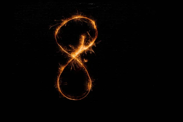 Number 8 made of sparklers on black — Stock Photo, Image