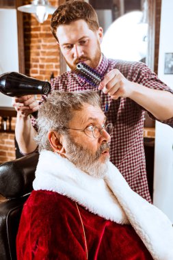 Santa claus shaving his personal barber clipart