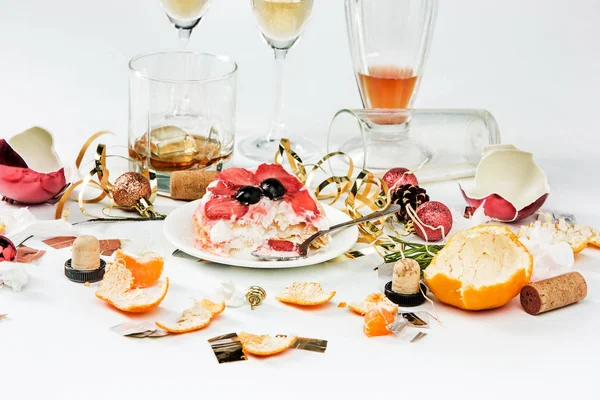 The morning after christmas day, table with alcohol and leftovers from a celebratory feast on gray