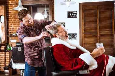 Santa claus shaving his personal barber clipart
