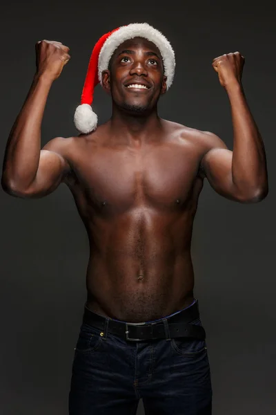 Musculoso negro sin camisa joven en Santa Claus sombrero — Foto de Stock