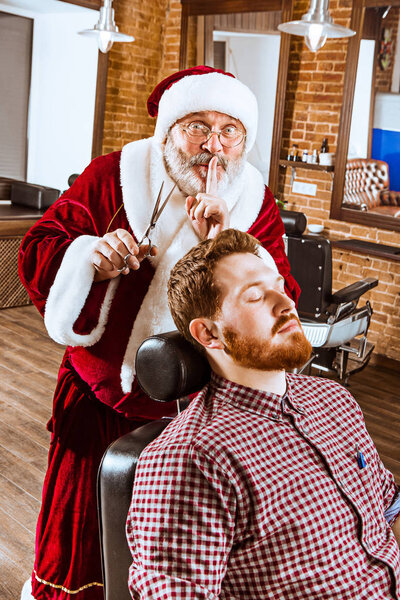 Santa claus as master at barber shop