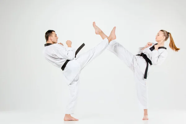 The karate girl and boy with black belts — Stock Photo, Image