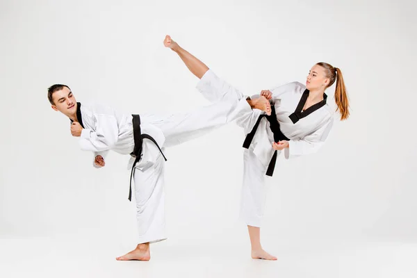 The karate girl and boy with black belts — Stock Photo, Image
