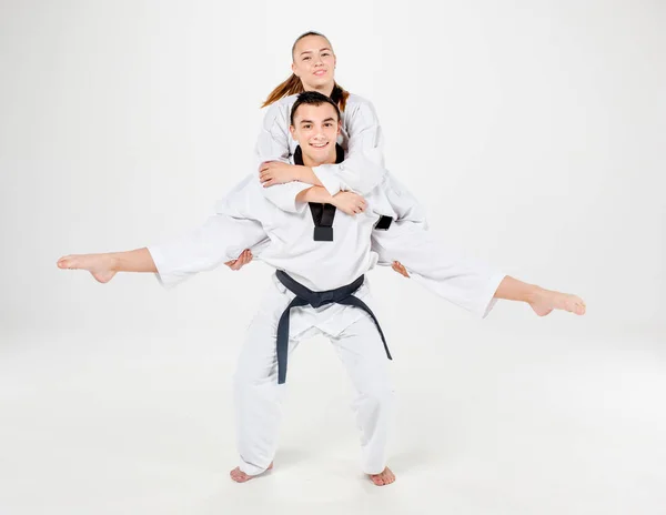 The karate girl and boy with black belts — Stock Photo, Image