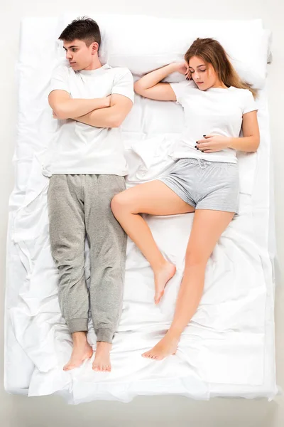 The young lovely couple lying in a bed — Stock Photo, Image