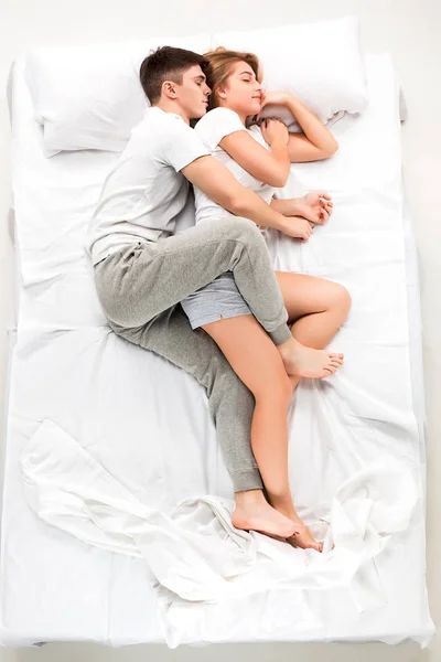 年轻可爱的情侣躺在床上 — 图库照片