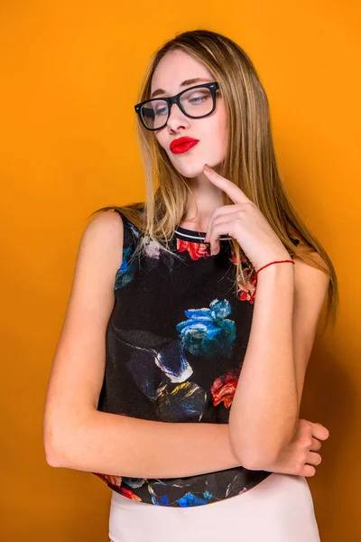 The serious frustrated young beautiful business woman on orange background — Stock Photo, Image