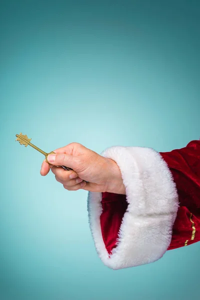 Hand van de Kerstman de knop ingedrukt op blauwe achtergrond — Stockfoto