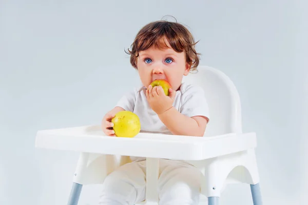 Menino feliz sentado e comendo — Fotografia de Stock