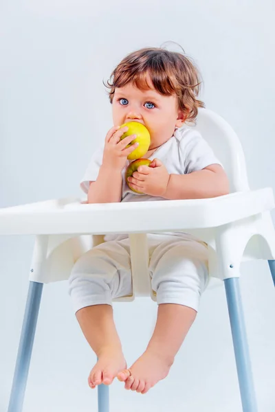 Menino feliz sentado e comendo — Fotografia de Stock