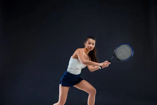 Portrait of beautiful girl tennis player with a racket on dark background — Stock Photo, Image