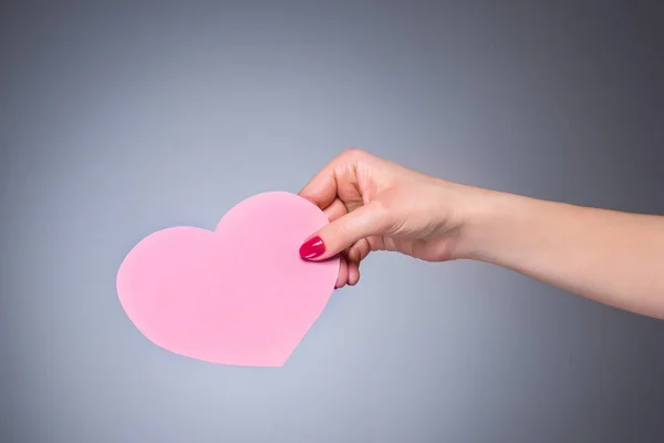 Heart shape love symbol in woman hand — Stock Photo, Image