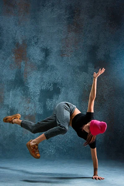 Jong meisje break dancing op muur achtergrond. — Stockfoto