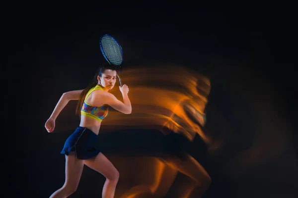 Portrait of beautiful girl tennis player with a racket on dark background — Stock Photo, Image