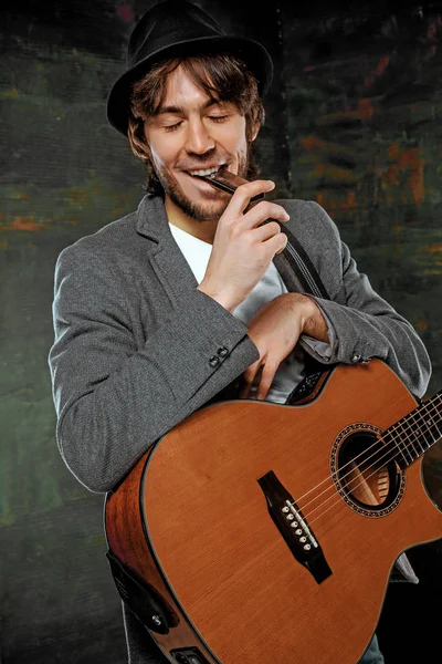 Cool guy with hat playing guitar on gray background — Stock Photo, Image
