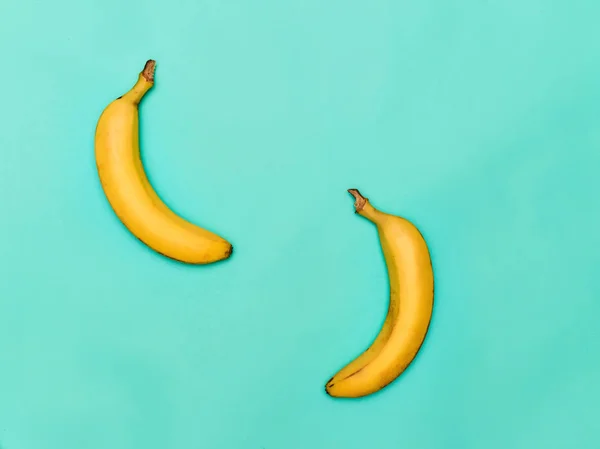 The two bananas against blue background — Stock Photo, Image