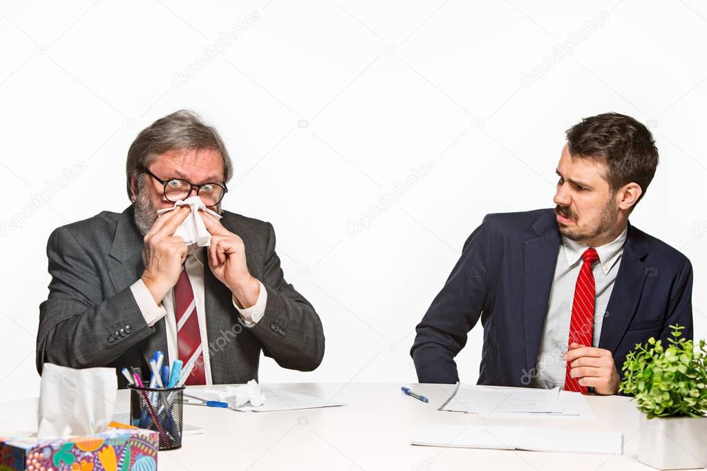 The two colleagues working together at office on white background.