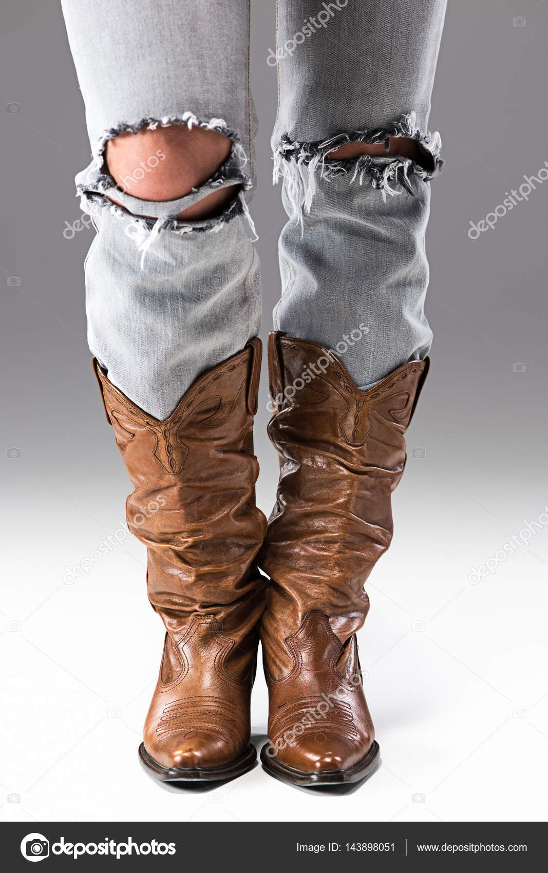 ripped jeans and cowboy boots