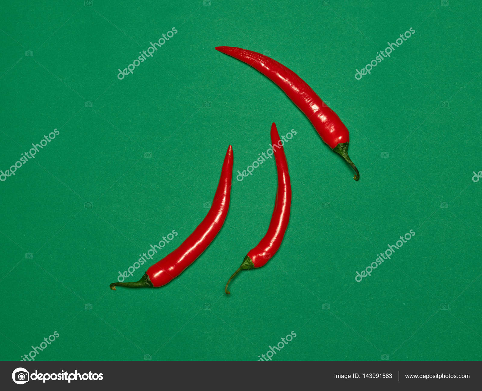 Bitter chili pepper and paprika on a green background Stock Photo by
