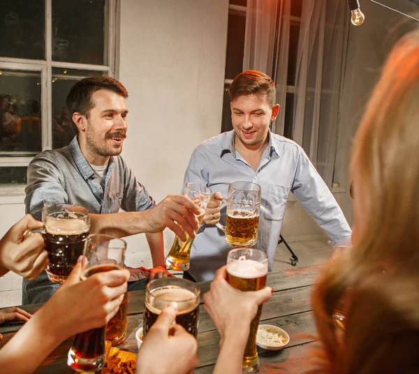 Gruppo di amici che si godono un drink serale con birra — Foto Stock