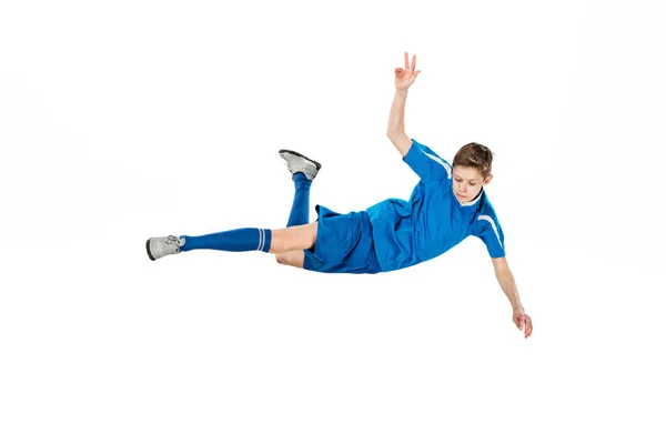 Niño con pelota de fútbol haciendo patada voladora —  Fotos de Stock