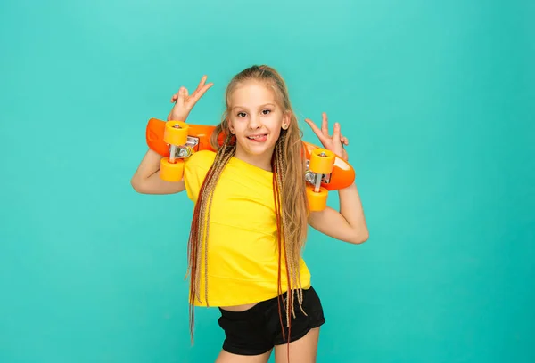 Pretty skater girl holding skateboard — Stock Photo, Image