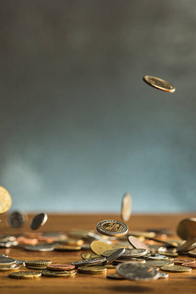 The silver and golden coins and falling coins on wooden background — Stock Photo, Image