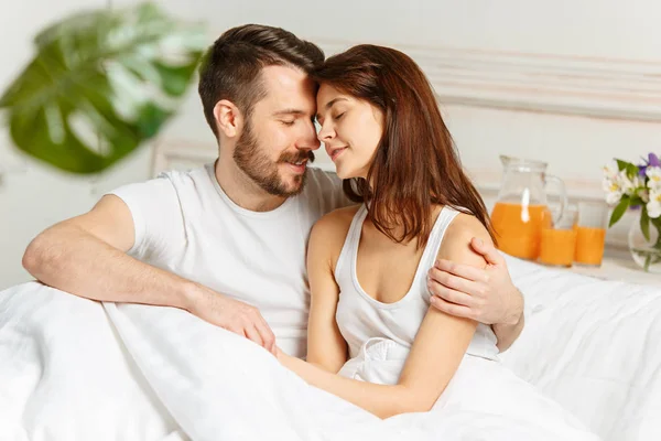 Молода доросла гетеросексуальна пара лежить на ліжку в спальні — стокове фото